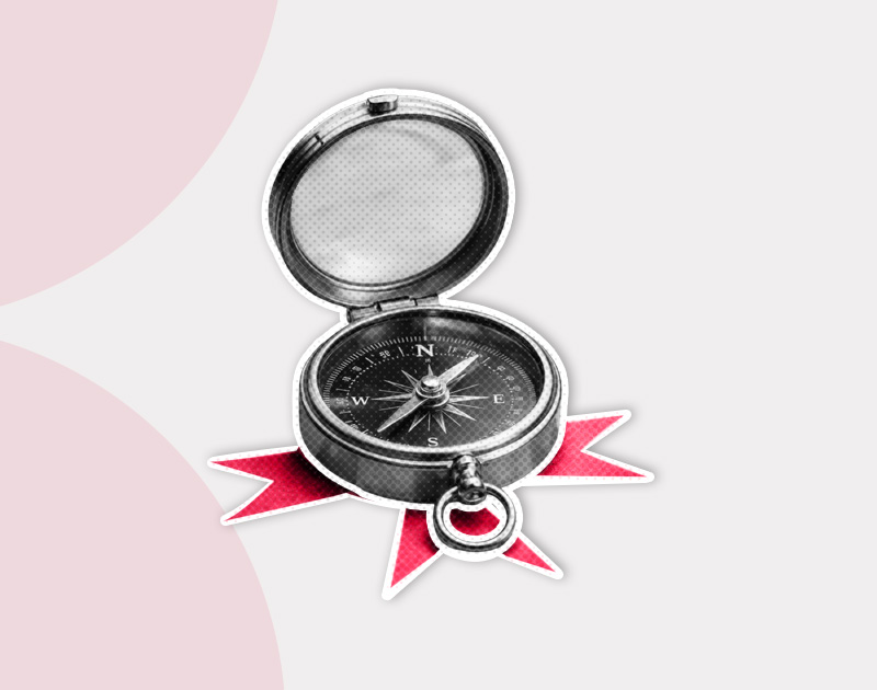 Open compass with a vintage design, resting on red, star-like rays. The background is light gray with soft pink arcs, conveying a sense of exploration.
